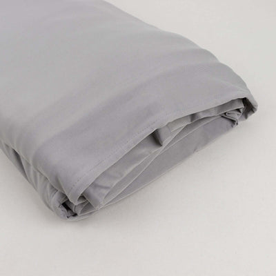 Gray folded bedding set on a plain background.