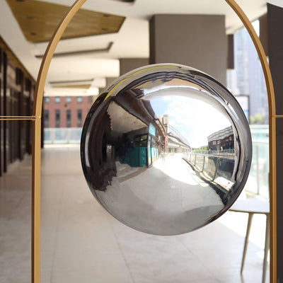 Reflective decorative sphere in modern architectural setting.