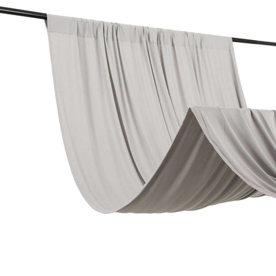 Gray fabric drapery hanging from a rod