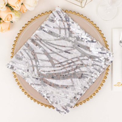 Silver sequin table napkin on a decorative plate