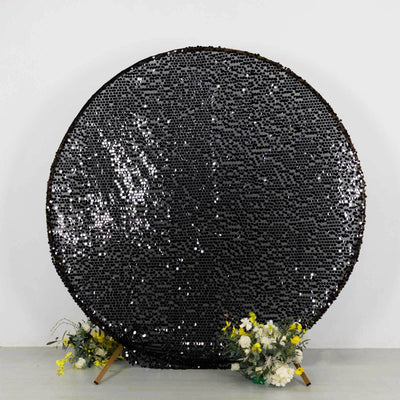 Black sequin round backdrop with floral accents for photoshoots.