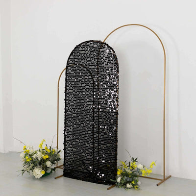 Black sequin backdrop with gold frame and floral accents.