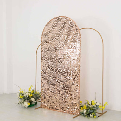 Rose gold sequin backdrop with floral arrangements for events and photography.