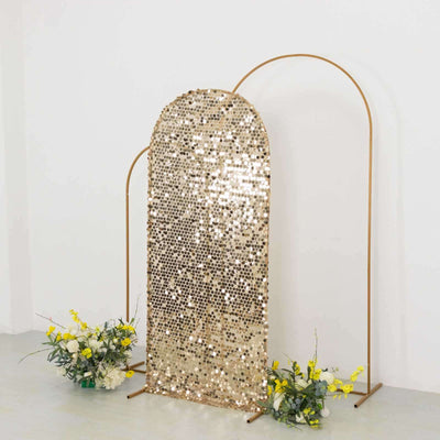 Gold sequin backdrop with arch frame and floral accents for events or photography.
