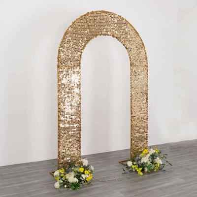 Gold sequin wedding arch with floral arrangements on both sides.