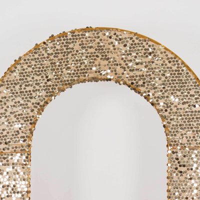 Gold sequin arch decoration with a shimmering finish.