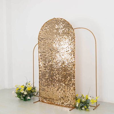 Gold sequin backdrop with floral arrangements for events and photography.