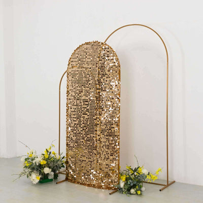 Gold sequin backdrop with arch frame and floral arrangements