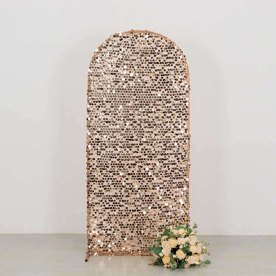 Rose gold sequin backdrop with floral arrangement in front