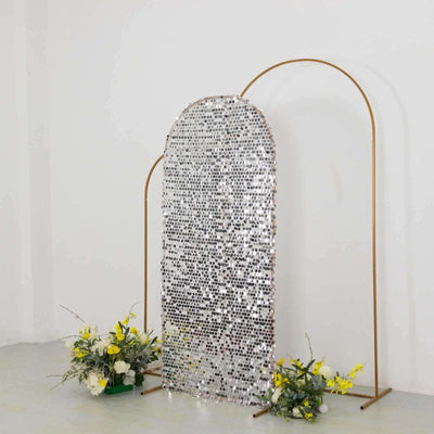 Silver mirror arch backdrop with floral arrangements.