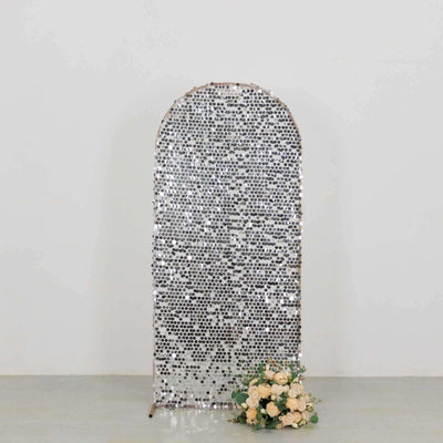 Silver sequin backdrop with floral arrangement at the base