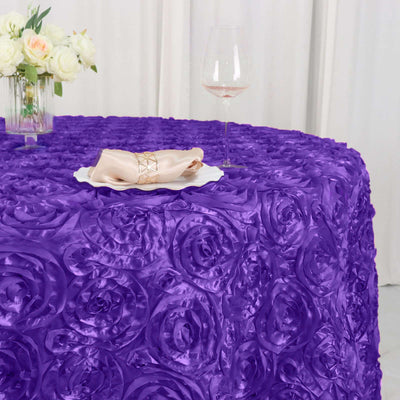 Purple rose-patterned tablecloth with a napkin and glass of wine.