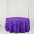 Purple rose-patterned tablecloth on a round table.