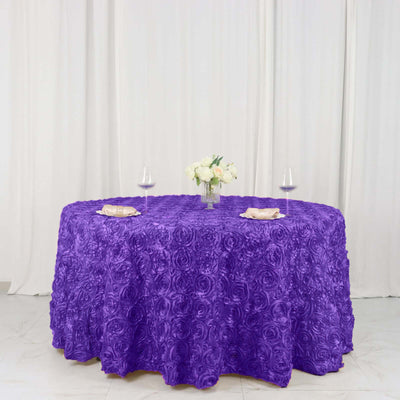 Purple rose-patterned tablecloth with floral centerpiece and wine glasses.