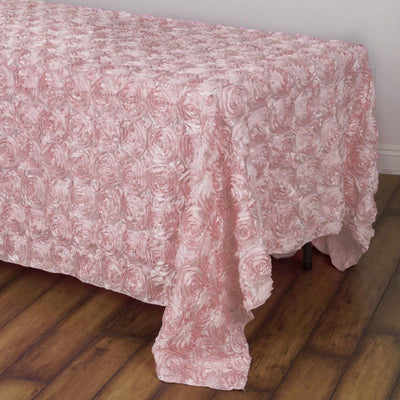 Pink rose-patterned tablecloth draping over a table.