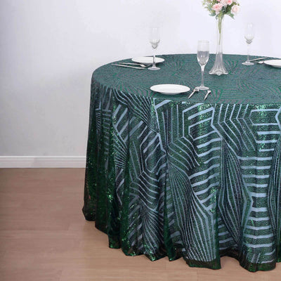 Green sequin tablecloth with leaf pattern on round table in elegant setting.