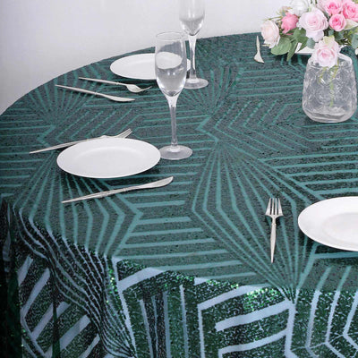 Green sequined tablecloth on a round table set for dining.