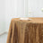 Gold sequin tablecloth with a glass and napkin on a table.