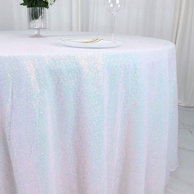Iridescent tablecloth draping elegantly over a round table.