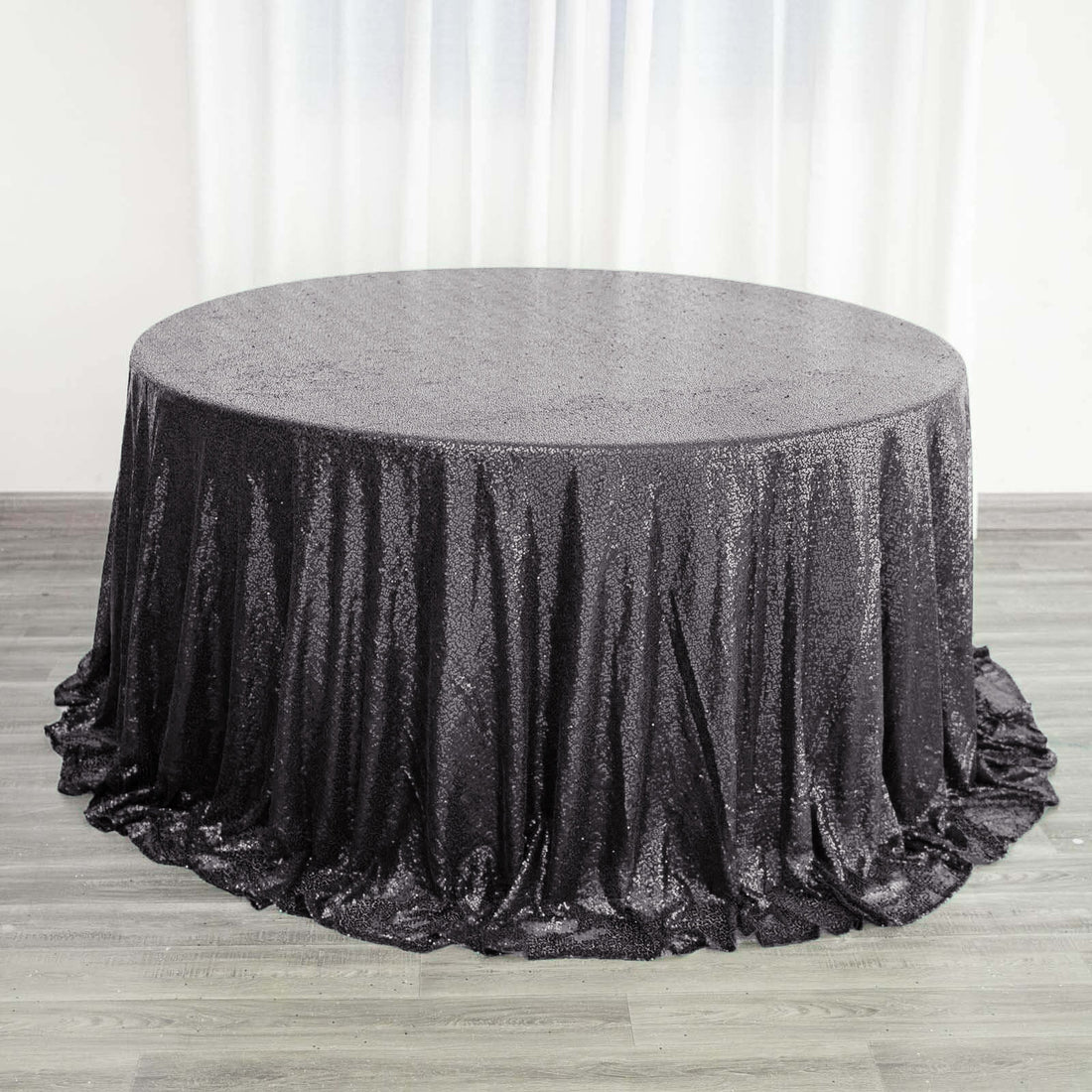 Black sequin tablecloth draping elegantly over a round table