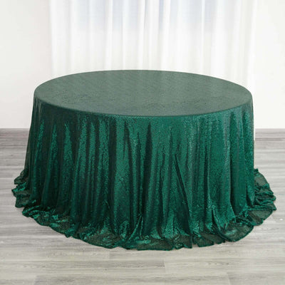 Green sequined tablecloth draped elegantly over a round table.