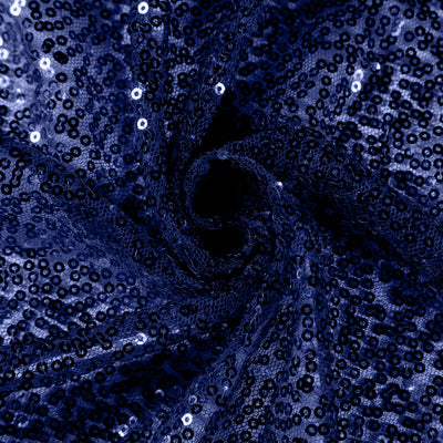 Navy blue sequined fabric texture in a swirling pattern.