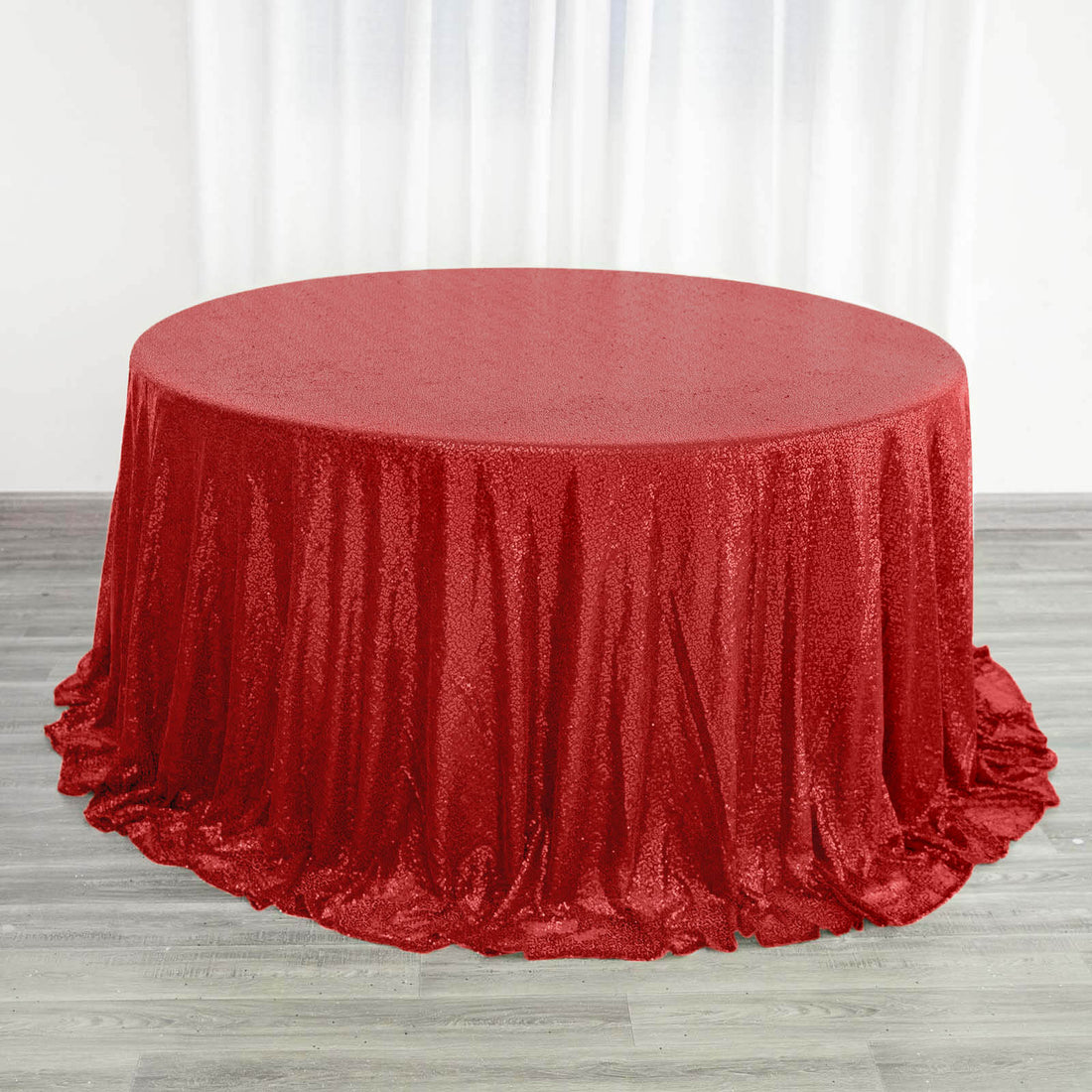 Red sequin tablecloth draped elegantly over a round table.