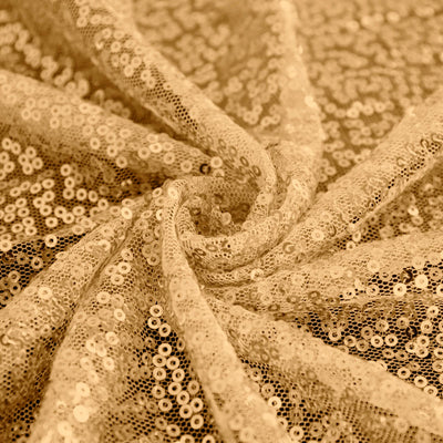 Gold sequin fabric draped in elegant folds. #whtbkgd