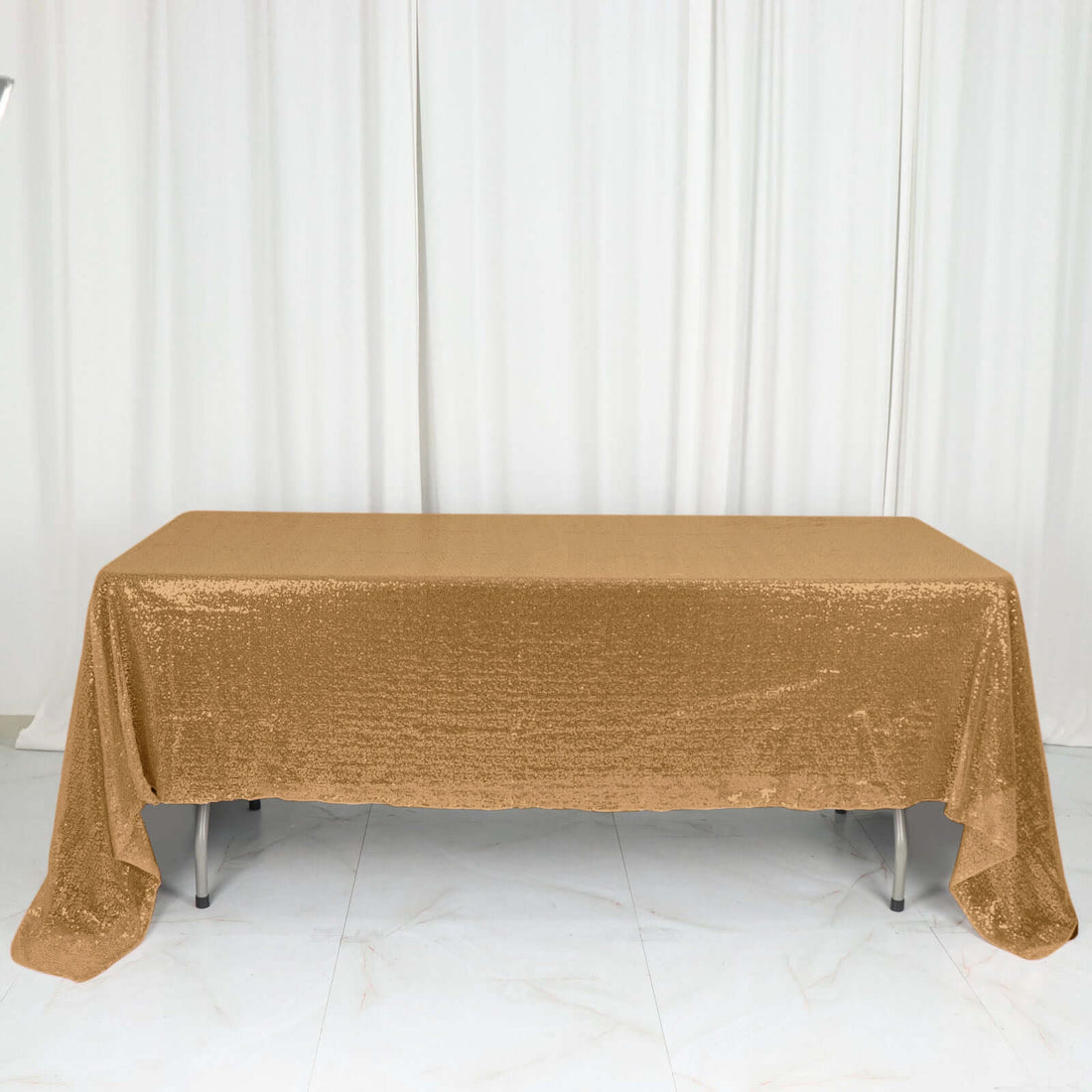 Gold sequin tablecloth draped over a table.