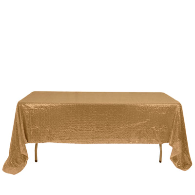 Gold sequin tablecloth draped over a table in studio-style isolation shot