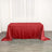 Red sequin tablecloth draped over a table in a bright setting.