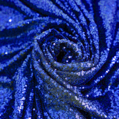 Blue sequin fabric draped in a spiral pattern. #whtbkgd