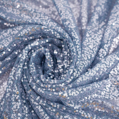 Blue sequin fabric draped in a swirl pattern. #whtbkgd