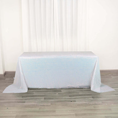 Shimmering iridescent tablecloth draped over a table in a studio setting.