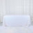 White sequin tablecloth draped over a table in a studio setting.