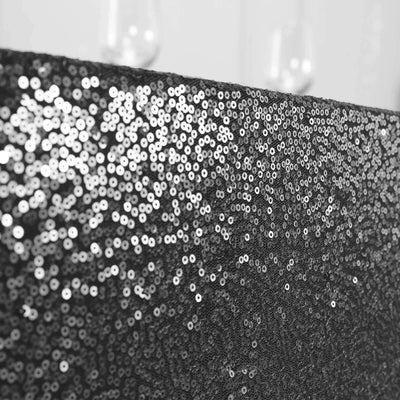 Black sequined fabric with shimmering texture.