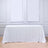 White lace tablecloth on a wooden table in a bright setting.