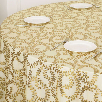 Elegant gold leaf patterned tablecloth on a cream background.
