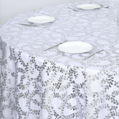 Silver sequin tablecloth on a round table set for dining.