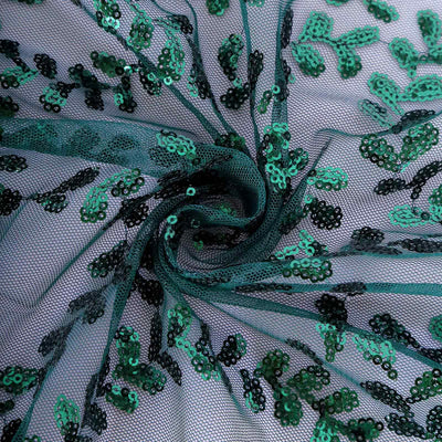 Green and black sequin embroidered mesh fabric swirl.