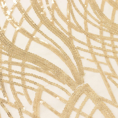 Gold sequin fabric with intricate patterns and textures.