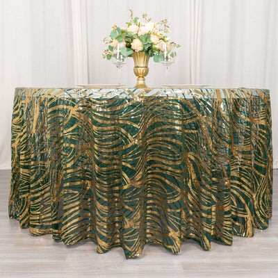 Green and gold wavy tablecloth with floral centerpiece and glasses