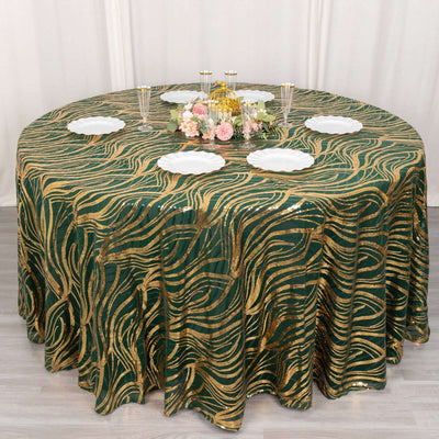 Round green and gold patterned tablecloth on a dining table with plates and decor.