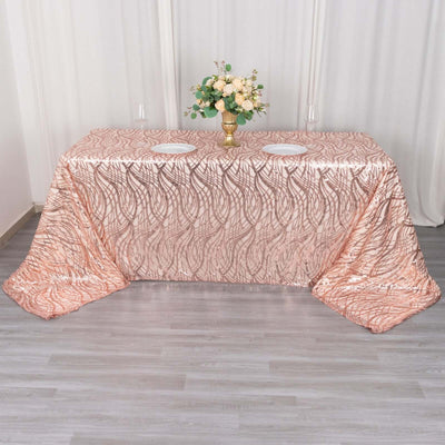 Rose gold tablecloth with elegant wave pattern, styled for events.