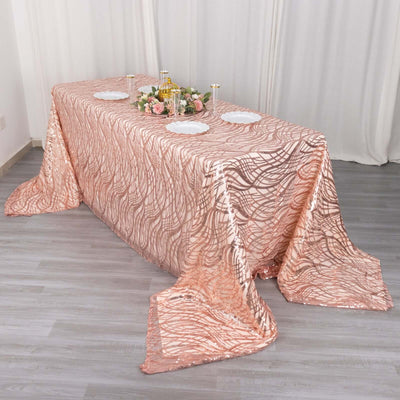 Rose gold sequin tablecloth on a decorated table for events or parties.