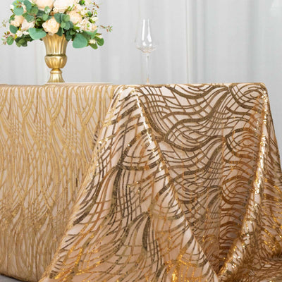 Gold sequin tablecloth draped elegantly over a table with a floral centerpiece.