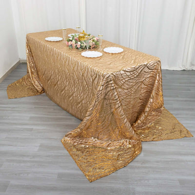 Gold textured tablecloth with elegant wave patterns and decorative plates.