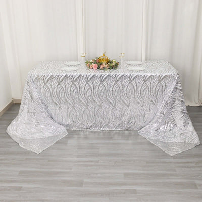 Elegant silver sequin tablecloth with intricate pattern, perfect for events and decorations.