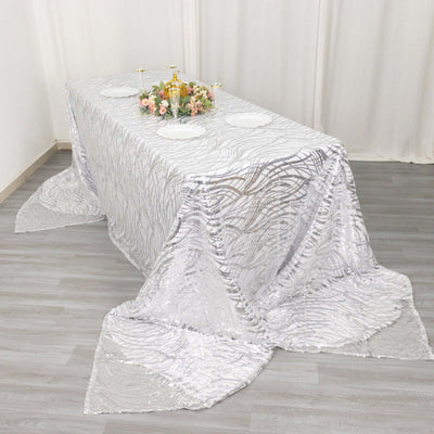 Elegant silver tablecloth with textured pattern draped over a table.