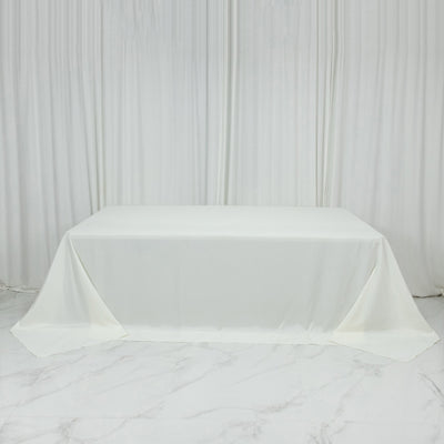 White tablecloth draped elegantly over a table against a plain backdrop.